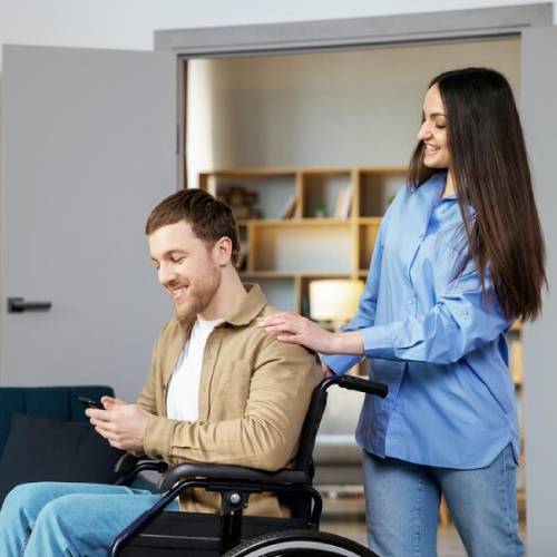Disability support service with caregiver assisting wheelchair user